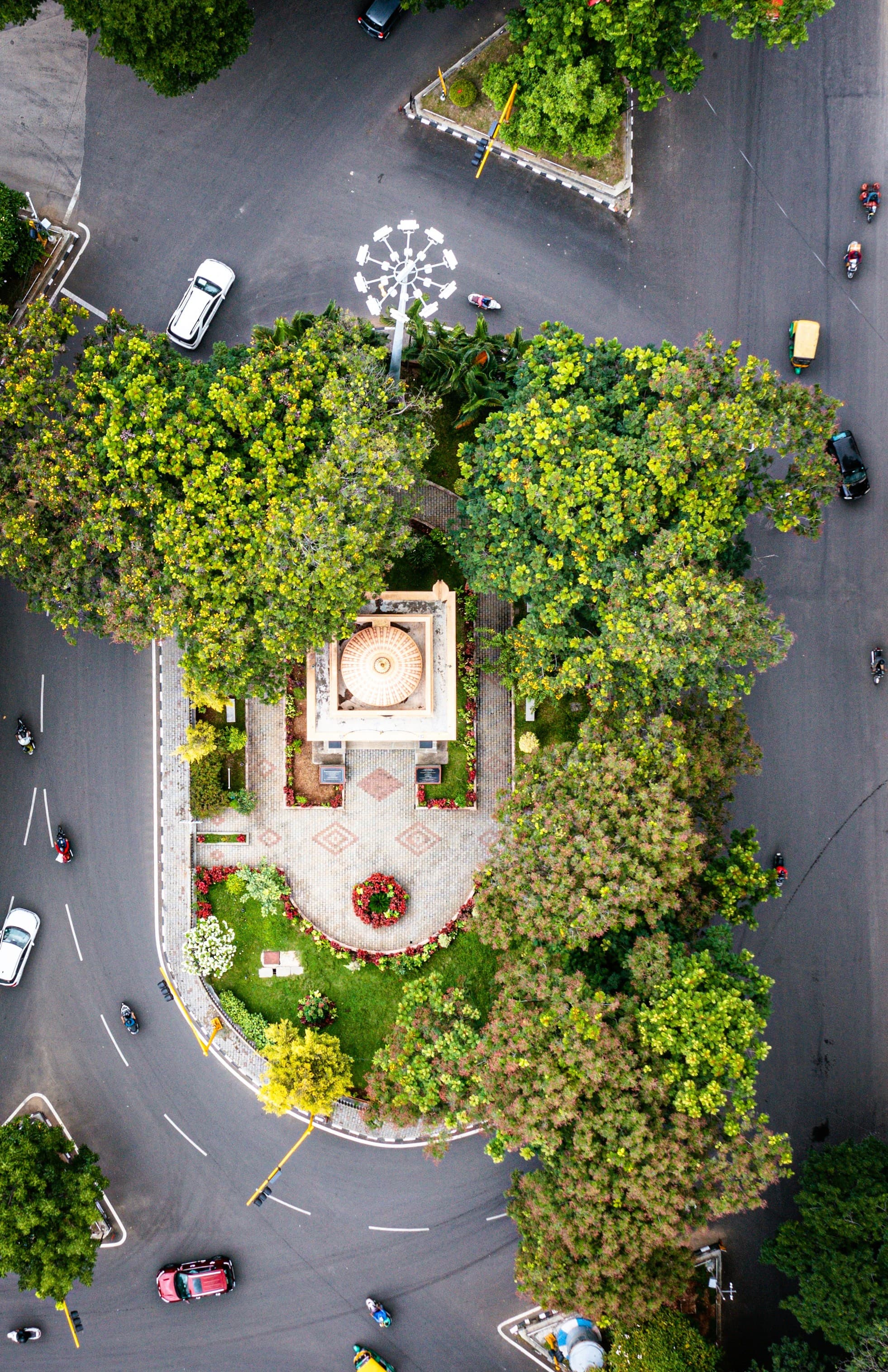 Aerial view of a landscaped traffic circle with heritage architecture in Bengaluru
